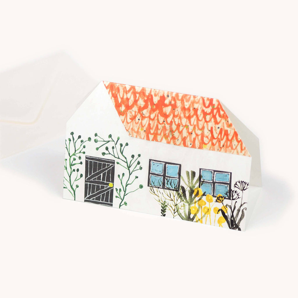 Detail van het huisje met kat in de tuin
