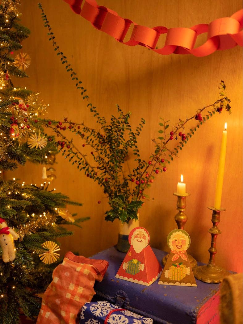 Detail van de vrolijke kerstman met bel en cadeau