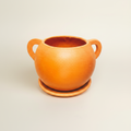 Terracotta pot met oren warme achtergrond
